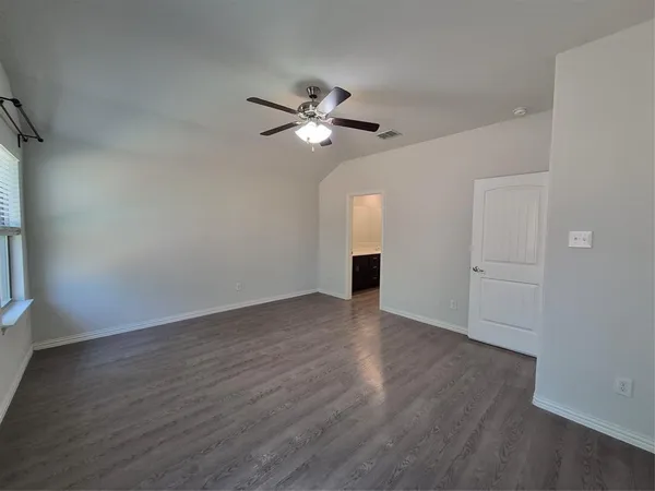 a large kitchen with stainless steel appliances a large counter top a stove and a refrigerator