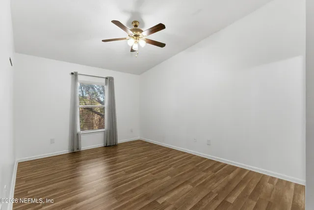 wooden floor in an empty room with a window