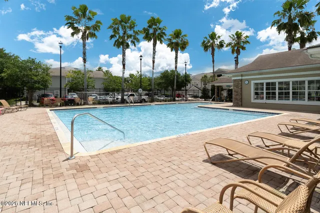 a view of a swimming pool with a lounge chairs