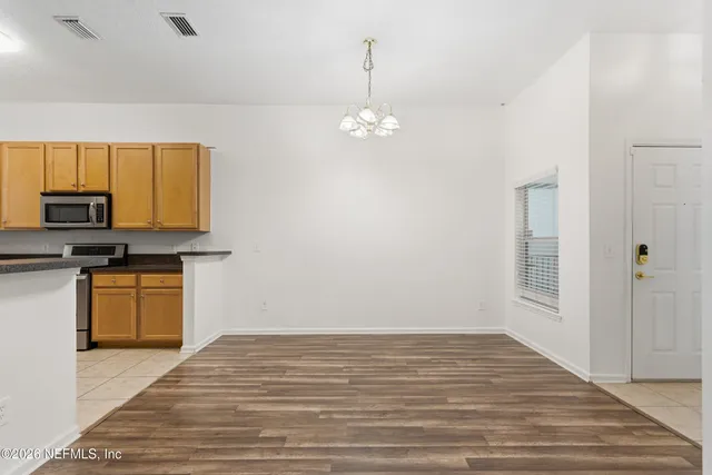 a view of kitchen with granite countertop cabinets and wooden floor