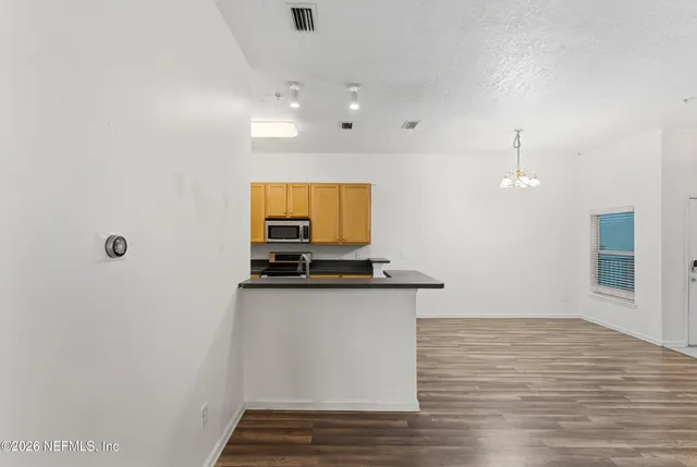 a view of a kitchen with a sink and a microwave