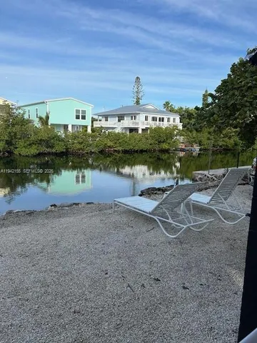 a view of a water pond with green space