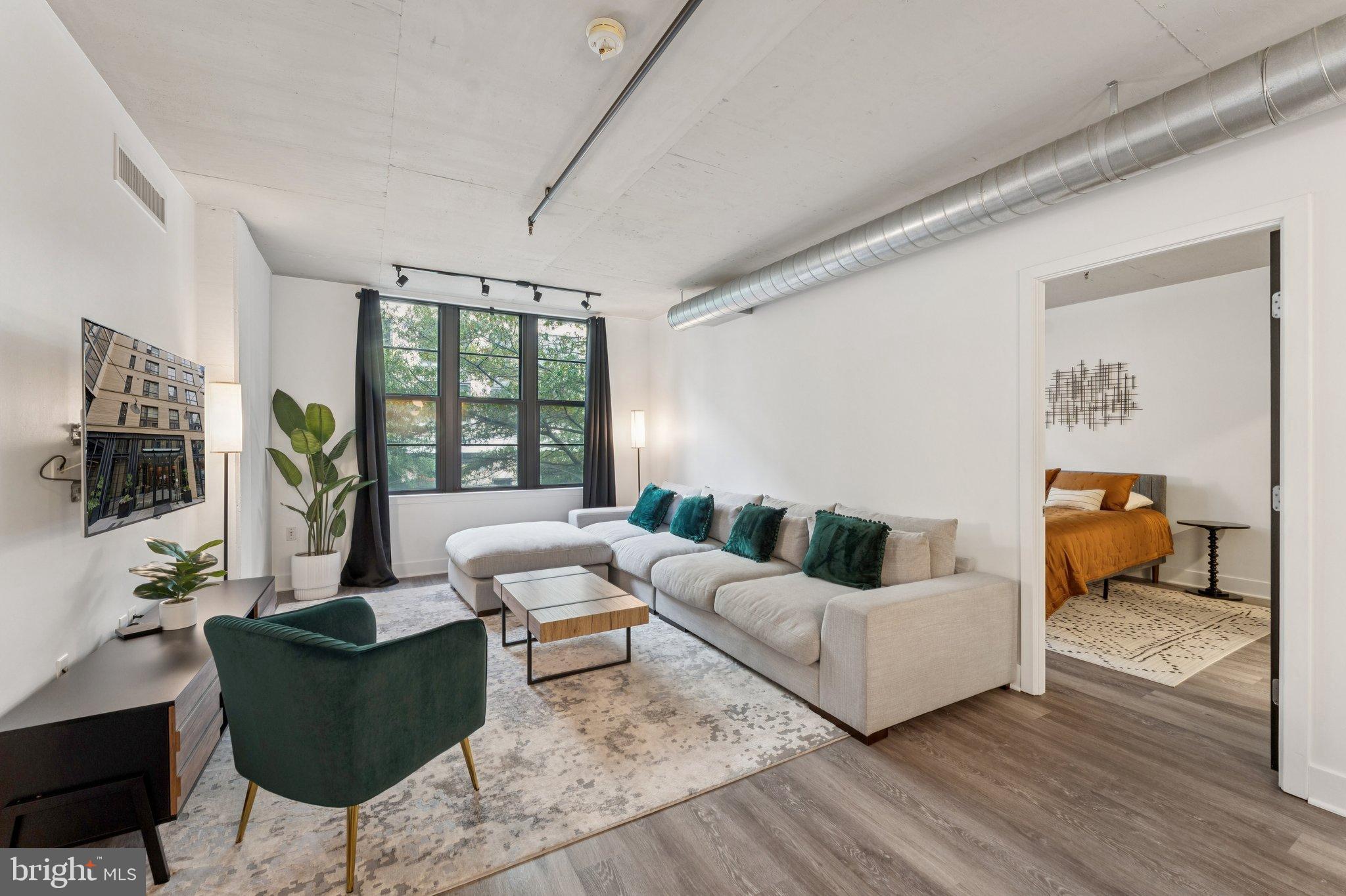 2125 14th Street Northwest, Unit 230 Washington, DC 20009 - Photo 1 of 17 a living room with furniture and a flat screen tv