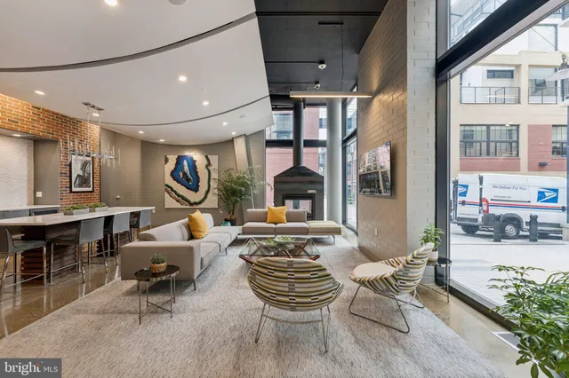 a living room with fireplace furniture and a large window