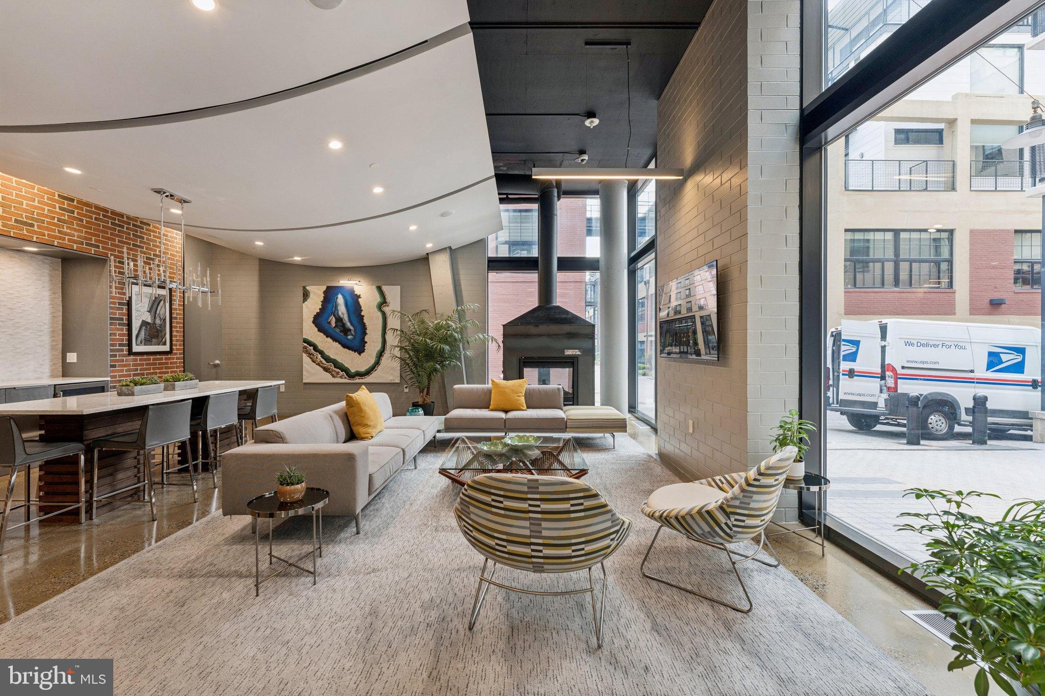 2125 14th Street Northwest, Unit 230 Washington, DC 20009 - Photo 15 of 17 a living room with fireplace furniture and a large window