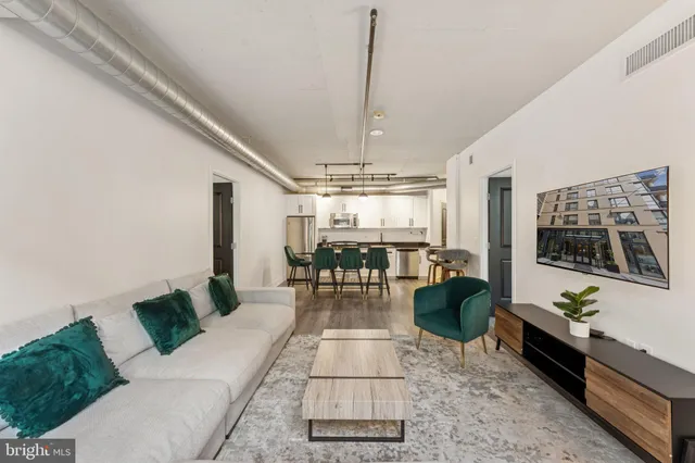 a living room with furniture and a chandelier
