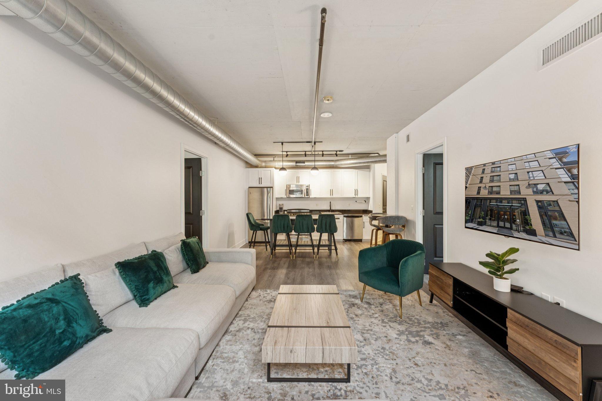 2125 14th Street Northwest, Unit 230 Washington, DC 20009 - Photo 2 of 17 a living room with furniture and a chandelier