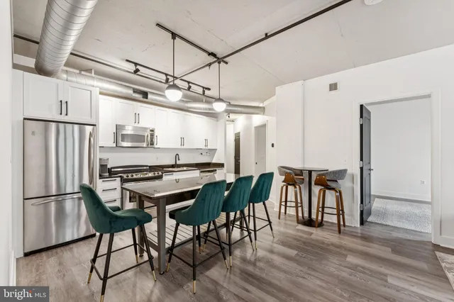a view of a dining room with furniture and wooden floor