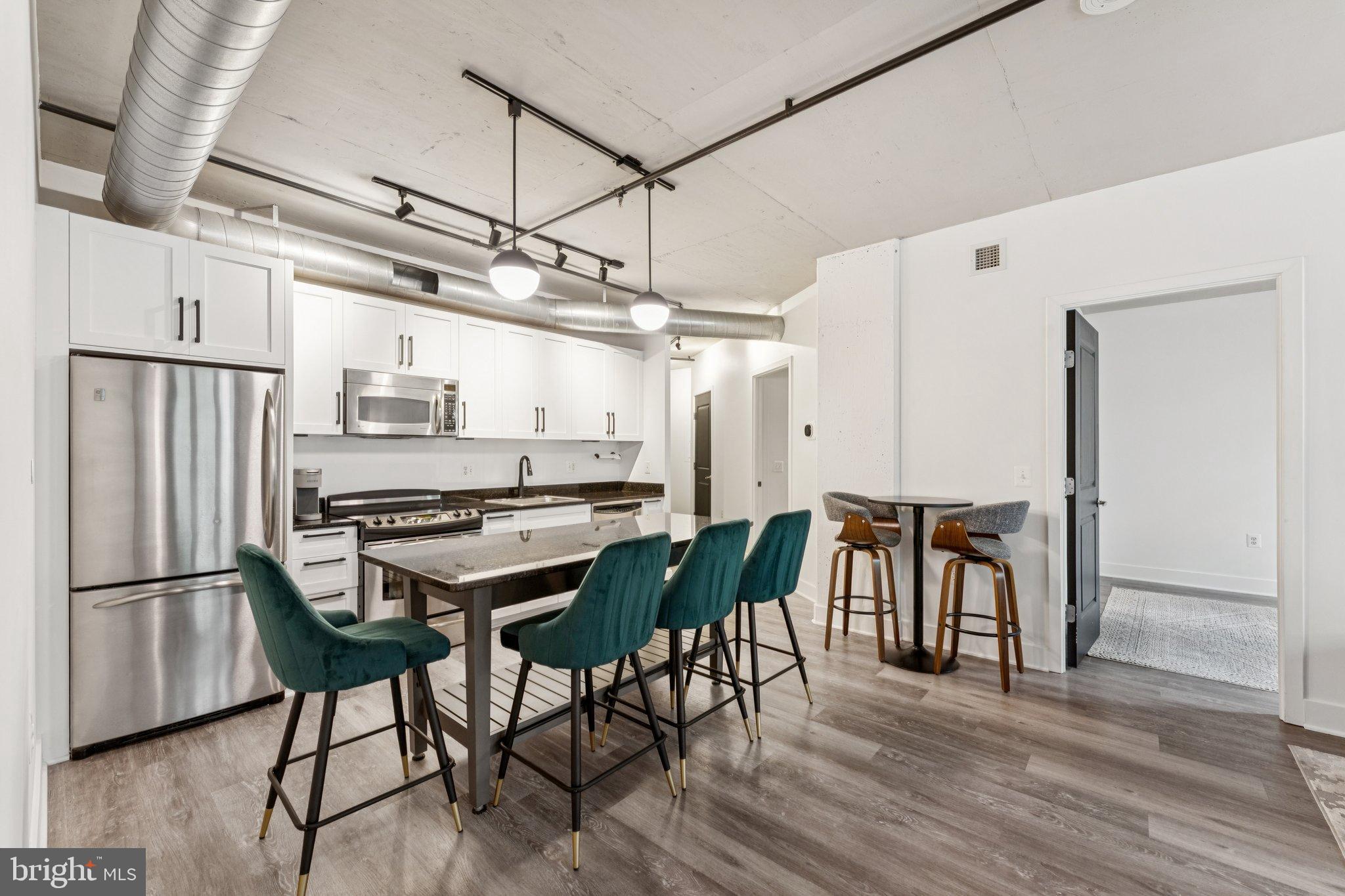 2125 14th Street Northwest, Unit 230 Washington, DC 20009 - Photo 4 of 17 a view of a dining room with furniture and wooden floor
