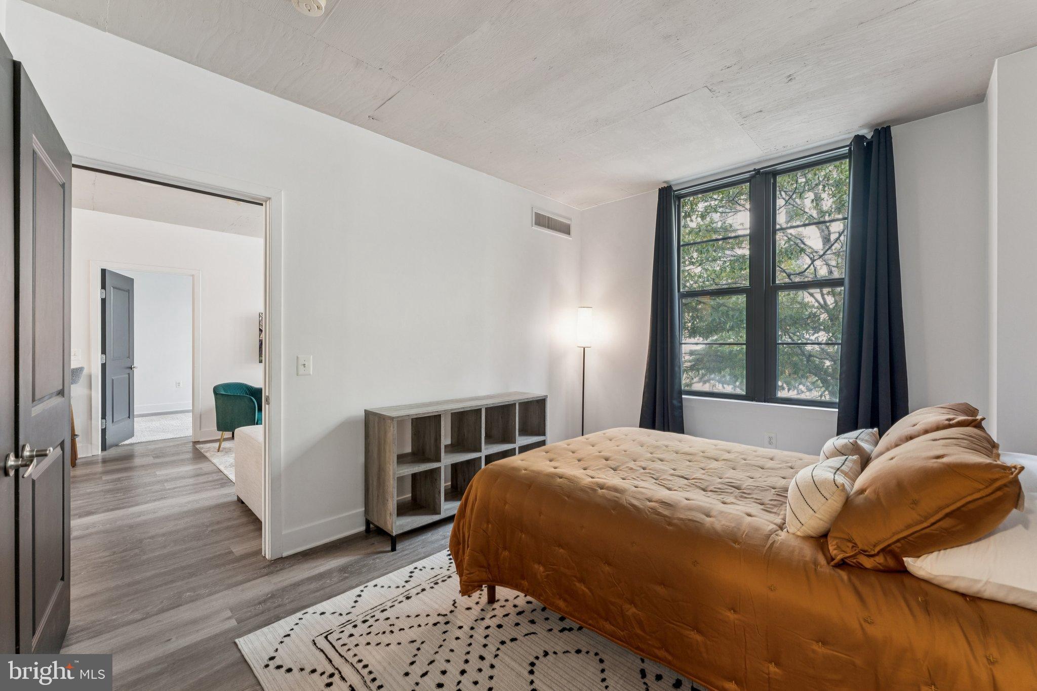 2125 14th Street Northwest, Unit 230 Washington, DC 20009 - Photo 5 of 17 a bedroom with a large bed and a window
