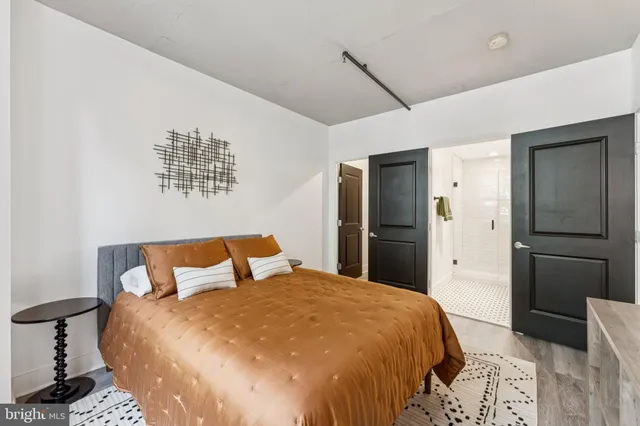 a bedroom with a bed and wooden floor