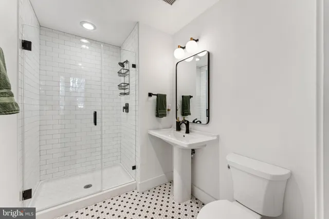 a bathroom with a toilet sink and shower