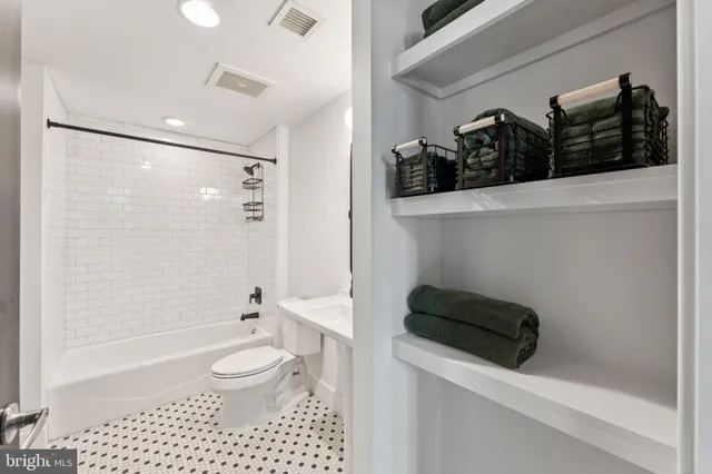 a bathroom with a toilet a sink and shower