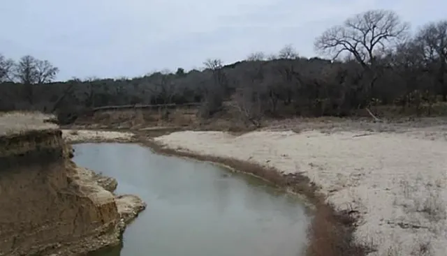 a view of a lake with a yard