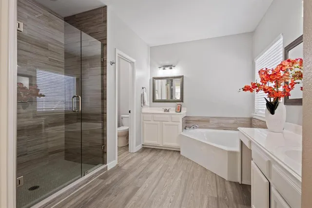 a bathroom with a tub sink and mirror