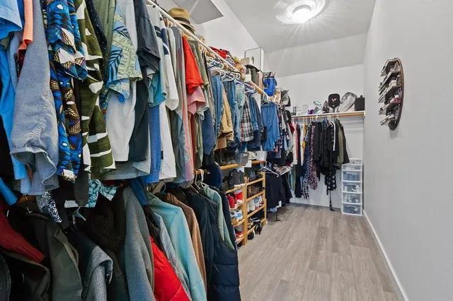a view of walk in closet with clothes