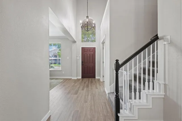 a view of a hallway with windows and stairs