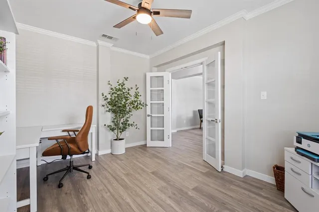 a workspace room with furniture and wooden floor