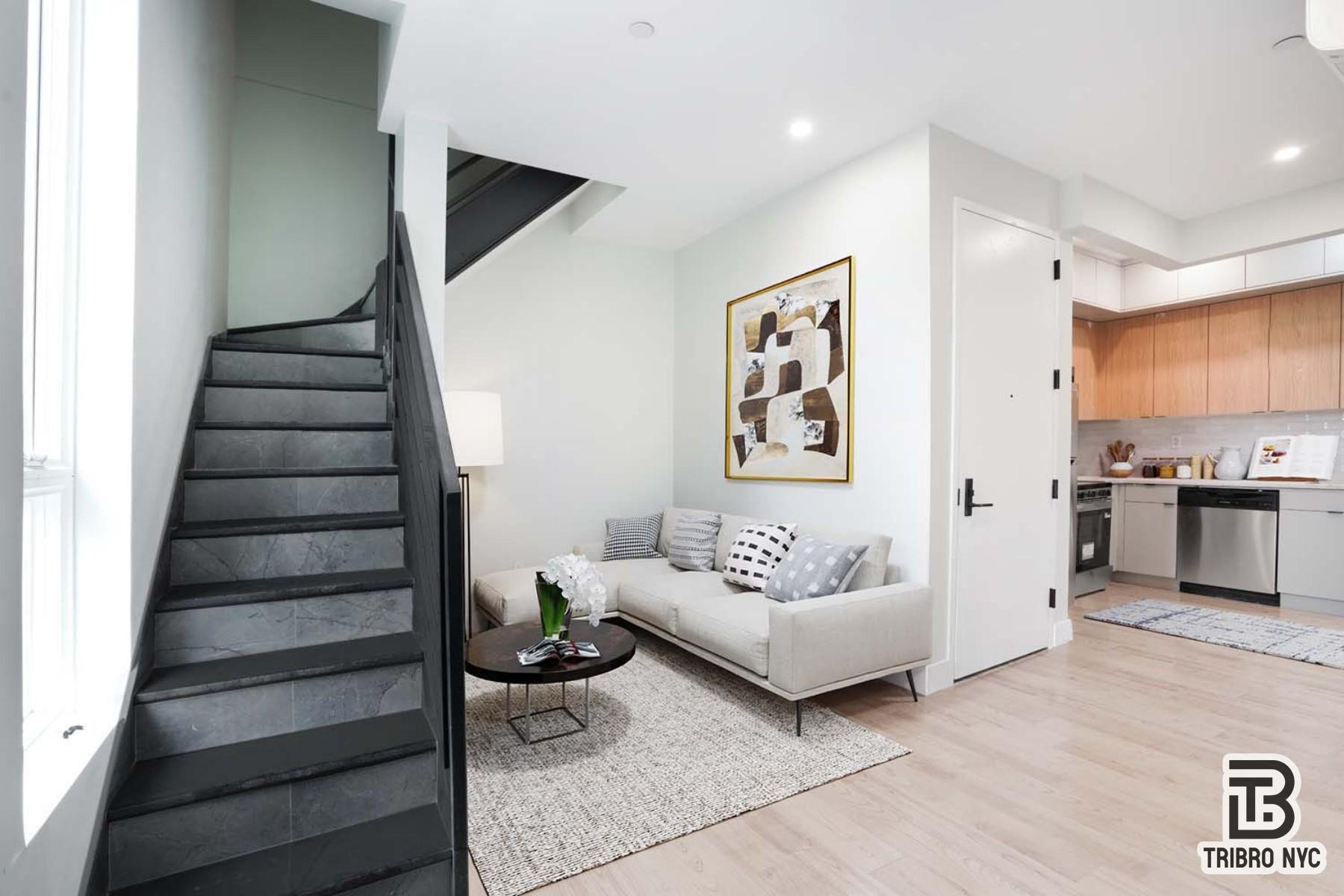 92 Manhattan Avenue, Unit 4X Brooklyn, NY 11206 - Photo 1 of 7 a living room with furniture and stairs