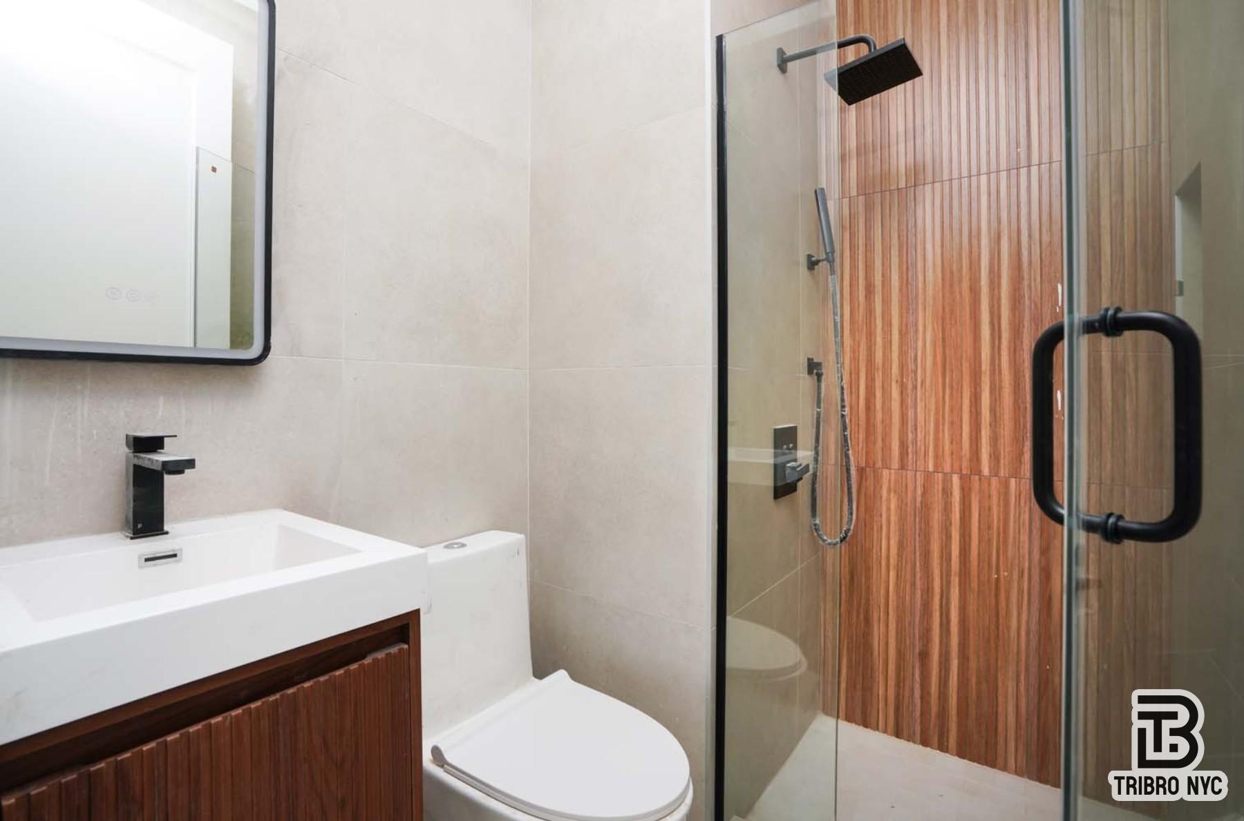 92 Manhattan Avenue, Unit 4X Brooklyn, NY 11206 - Photo 3 of 7 a bathroom with a sink a toilet and shower