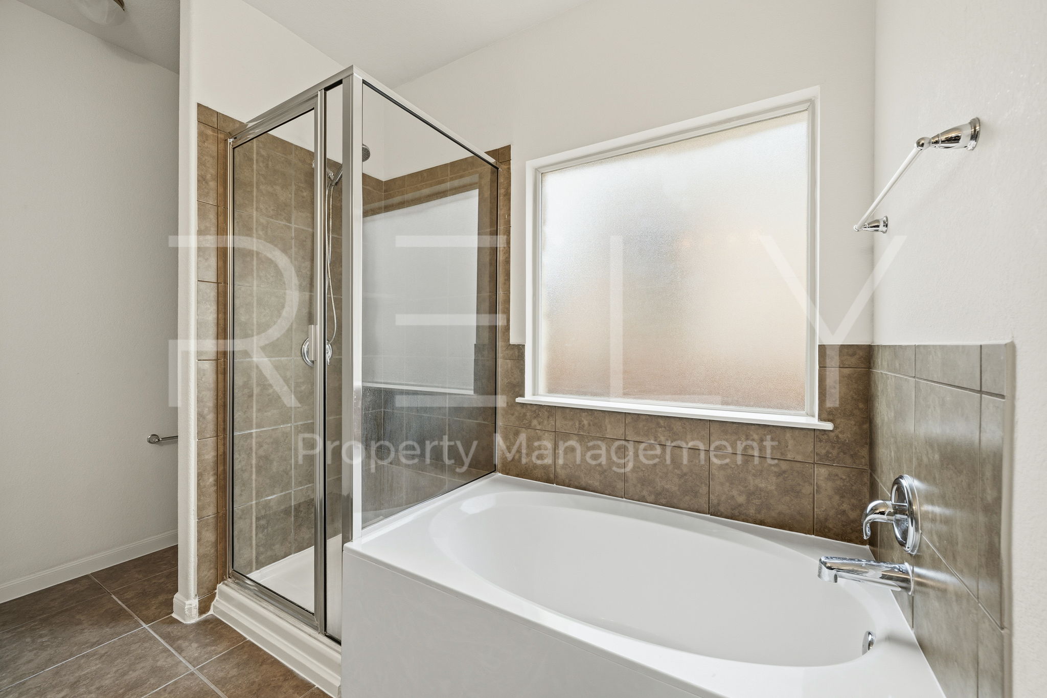 1405 Sunny Meadows Loop Georgetown, TX 78626 - Photo 21 of 40 Indulge in a tranquil bathing experience with this deep soaking tub and adjacent glass-enclosed shower.