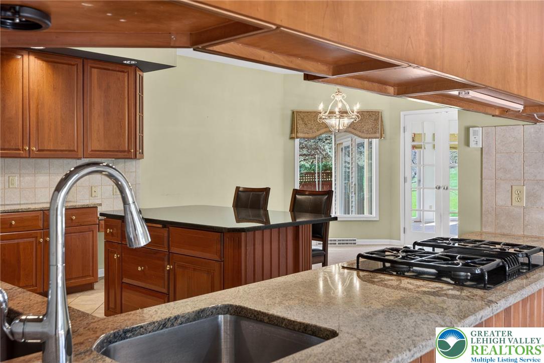 3190 Sheffield Drive Emmaus, PA 18049 - Photo 13 of 43 a kitchen with stainless steel appliances granite countertop a sink and a stove