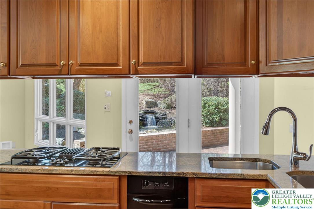 3190 Sheffield Drive Emmaus, PA 18049 - Photo 16 of 43 a kitchen with stainless steel appliances granite countertop a stove and a microwave