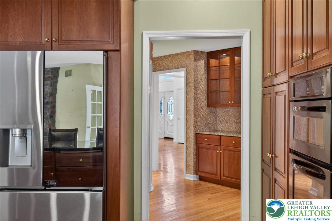3190 Sheffield Drive Emmaus, PA 18049 - Photo 18 of 43 a view of kitchen with a refrigerator cabinets and a wooden floor