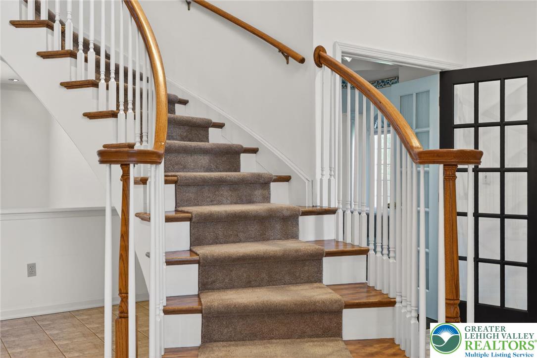3190 Sheffield Drive Emmaus, PA 18049 - Photo 26 of 43 a view of staircase with lots of frames on wall and a window