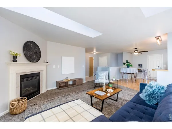 a living room with furniture a fireplace and a table