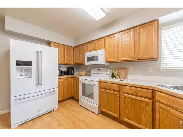 a kitchen with a refrigerator sink and cabinets