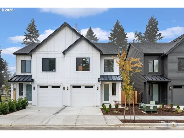 a view of a white house with large windows