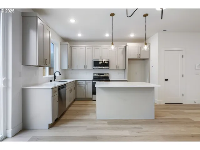a kitchen with a sink stainless steel appliances and cabinets