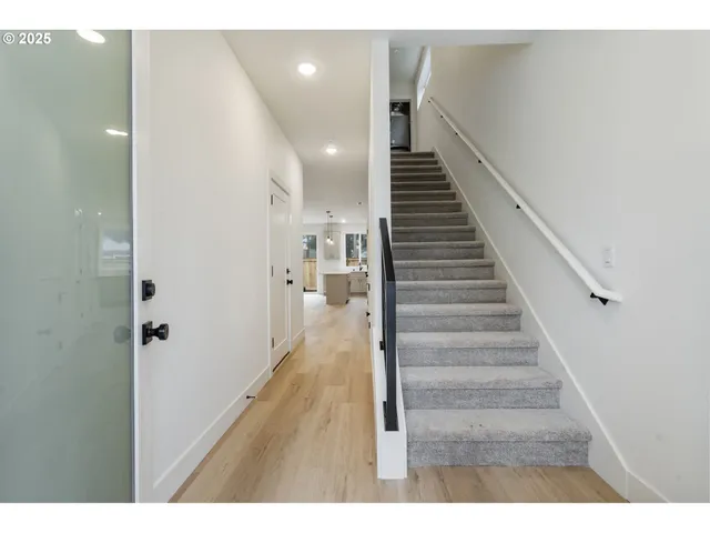 a view of entryway and hall with wooden floor