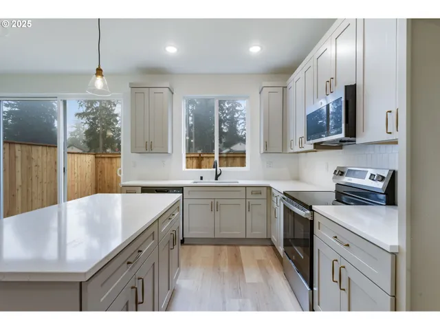 a kitchen with a sink stove and refrigerator