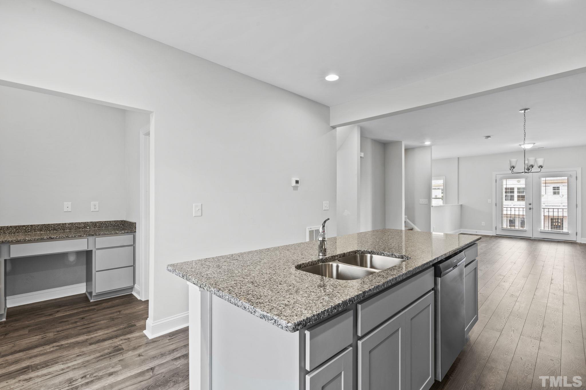 1150 Breadsell Lane Wake Forest, NC 27587 - Photo 4 of 33 a kitchen with center island wooden floor and a sink