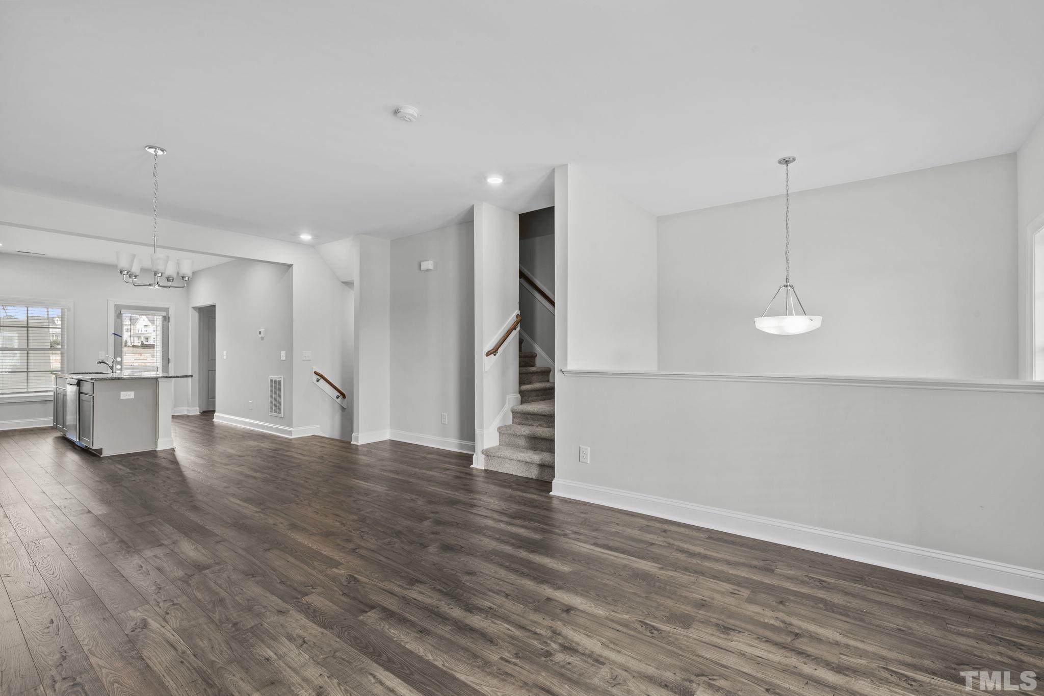 1150 Breadsell Lane Wake Forest, NC 27587 - Photo 6 of 33 a view of empty room with wooden floor and kitchen