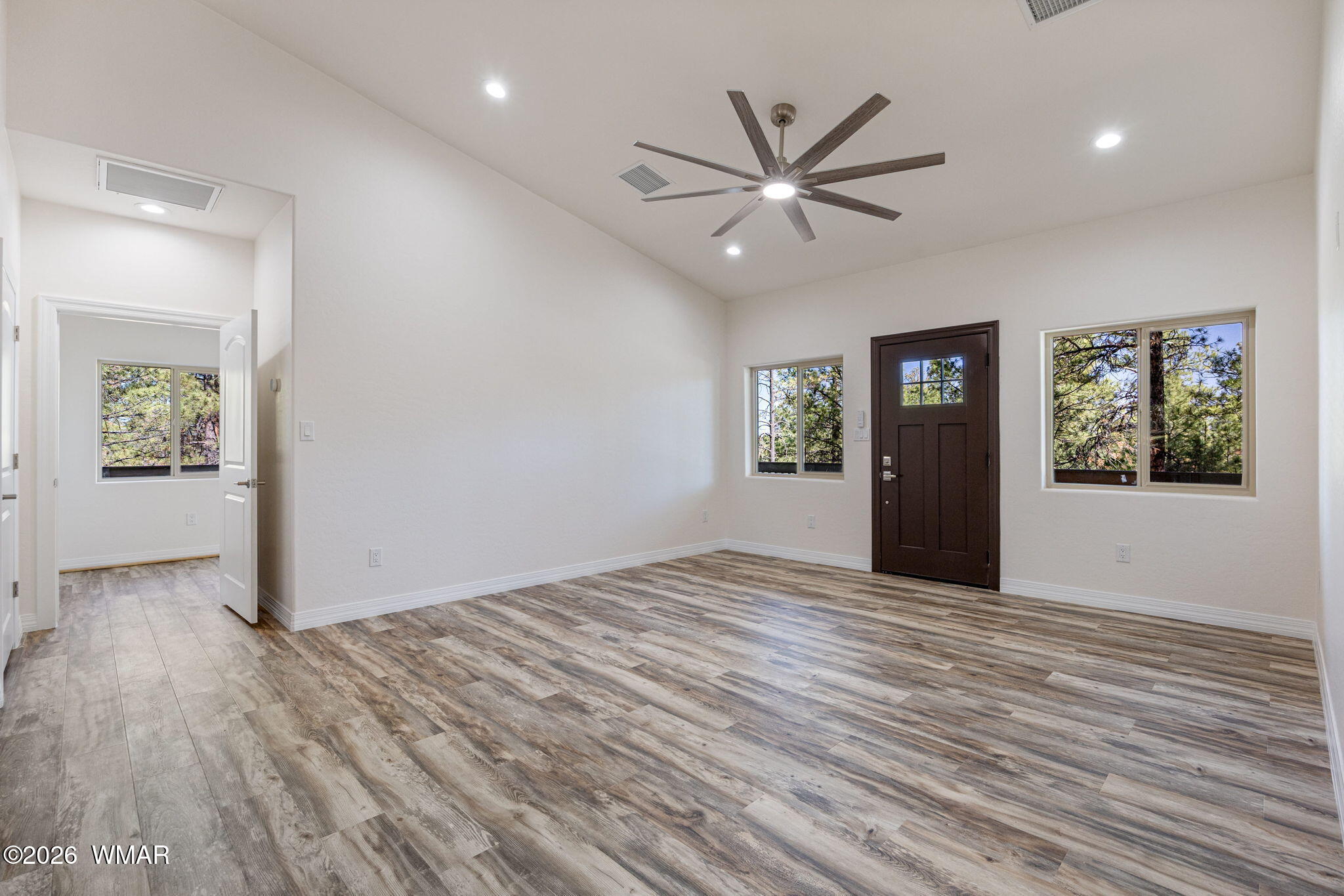 2273 Constellation Lane Overgaard, AZ 85933 - Photo 10 of 31 wooden floor in an empty room with a window