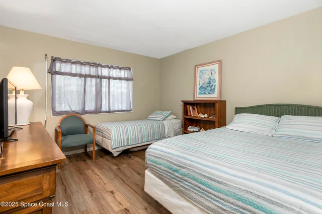 a bedroom with two beds and a window