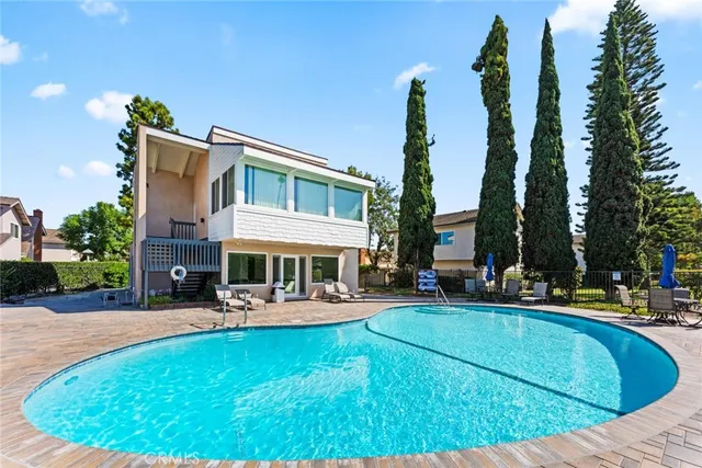 a view of a house with swimming pool and sitting area