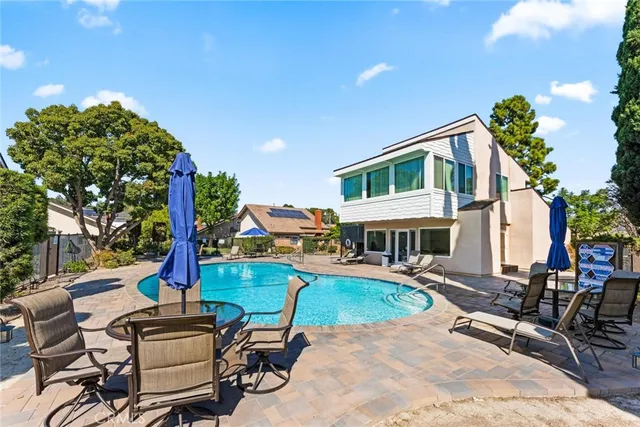 a view of a house with backyard porch and sitting area
