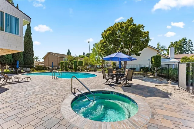 a swimming pool with outdoor seating yard and barbeque oven