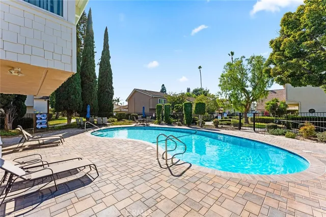 an outdoor space with swimming pool and furniture