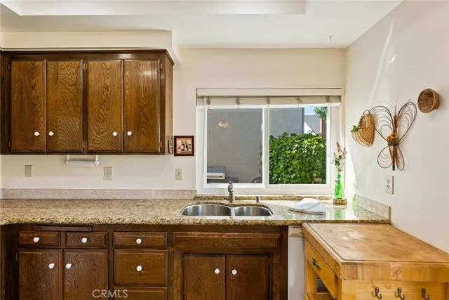 a bathroom with a granite countertop sink a mirror and a shower