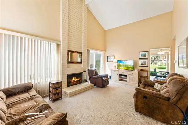 a living room with furniture fireplace and a flat screen tv