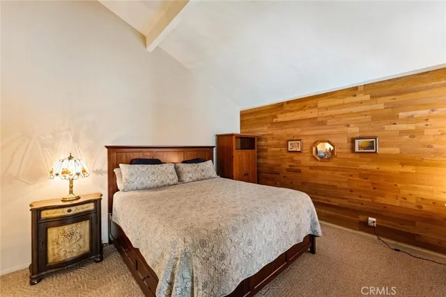 a bedroom with a bed and a night stand