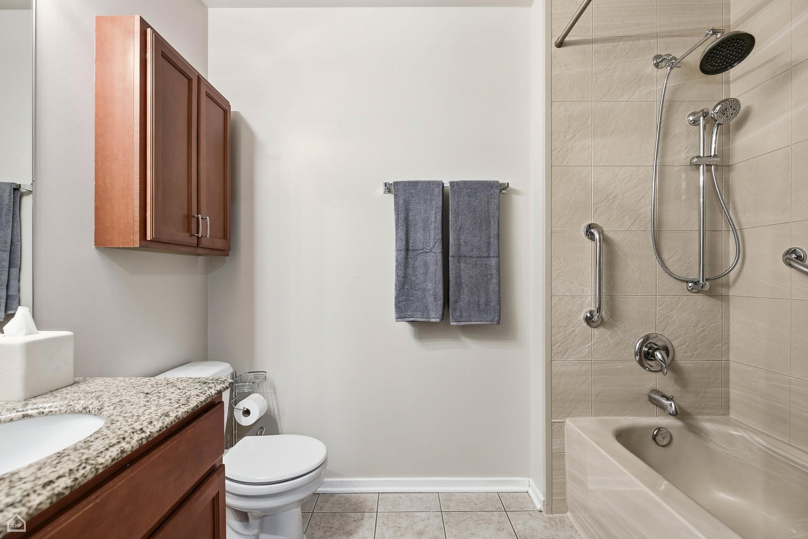 6 South Laflin Street, Unit 920 Chicago, IL 60607 - Photo 15 of 17 a bathroom with a granite countertop sink a toilet and shower
