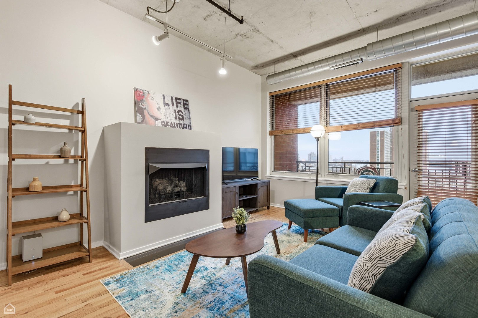 6 South Laflin Street, Unit 920 Chicago, IL 60607 - Photo 9 of 17 a living room with furniture a large window and a fireplace