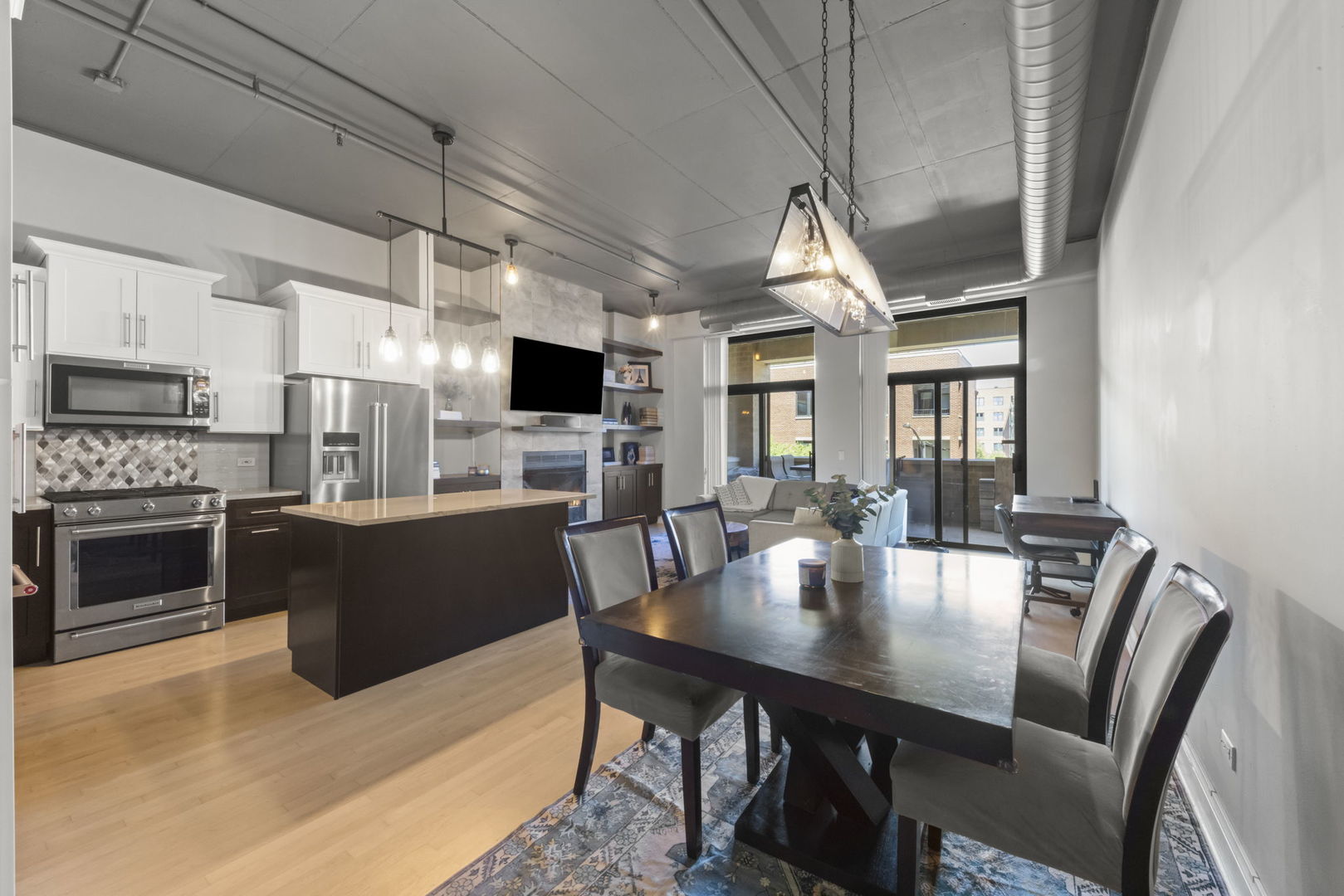 1301 West Madison Street, Unit 305 Chicago, IL 60607 - Photo 7 of 22 a view of kitchen with furniture and wooden floor