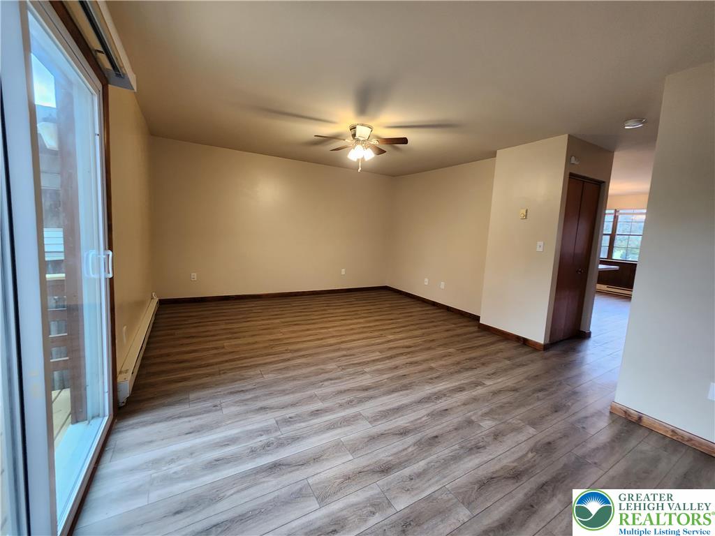 614 East Main Street Bath, PA 18014 - Photo 2 of 8 a view of a livingroom with wooden floor and a ceiling fan